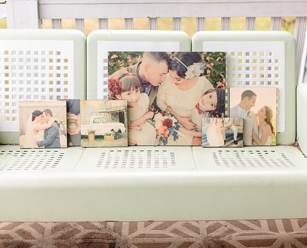 A collection of photoboard wood prints sitting on a piece of furniture