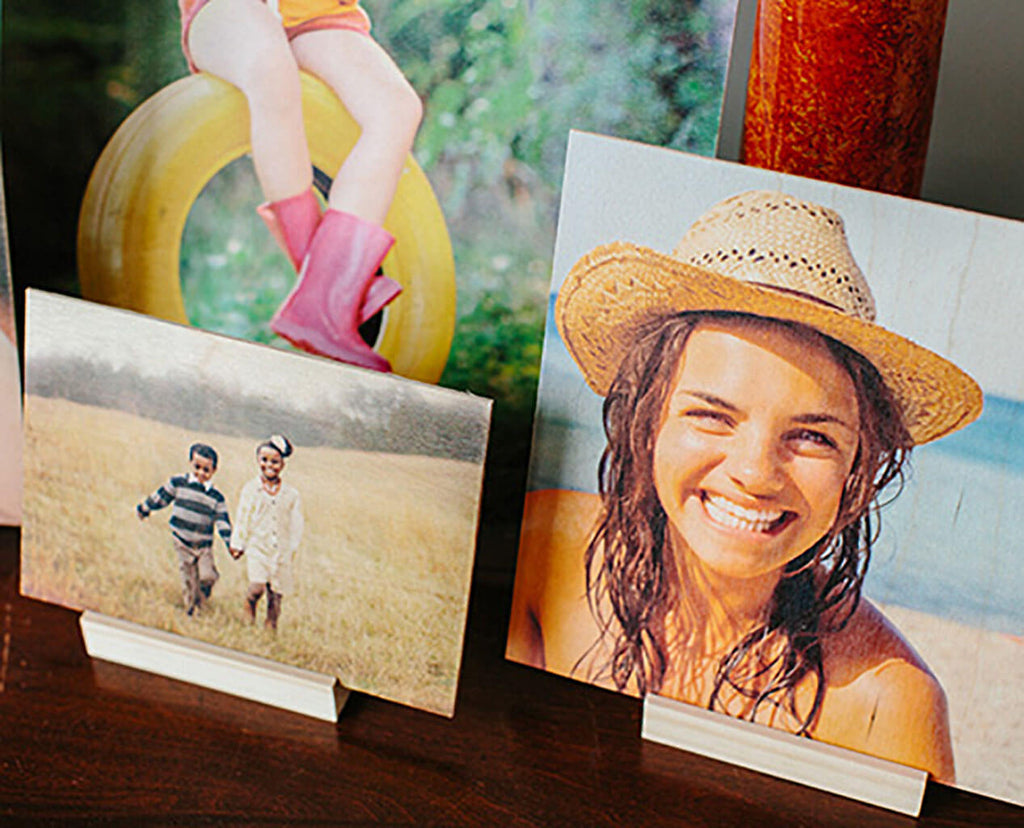 A detailed view of thee wood prints sitting in desk stands on a table.