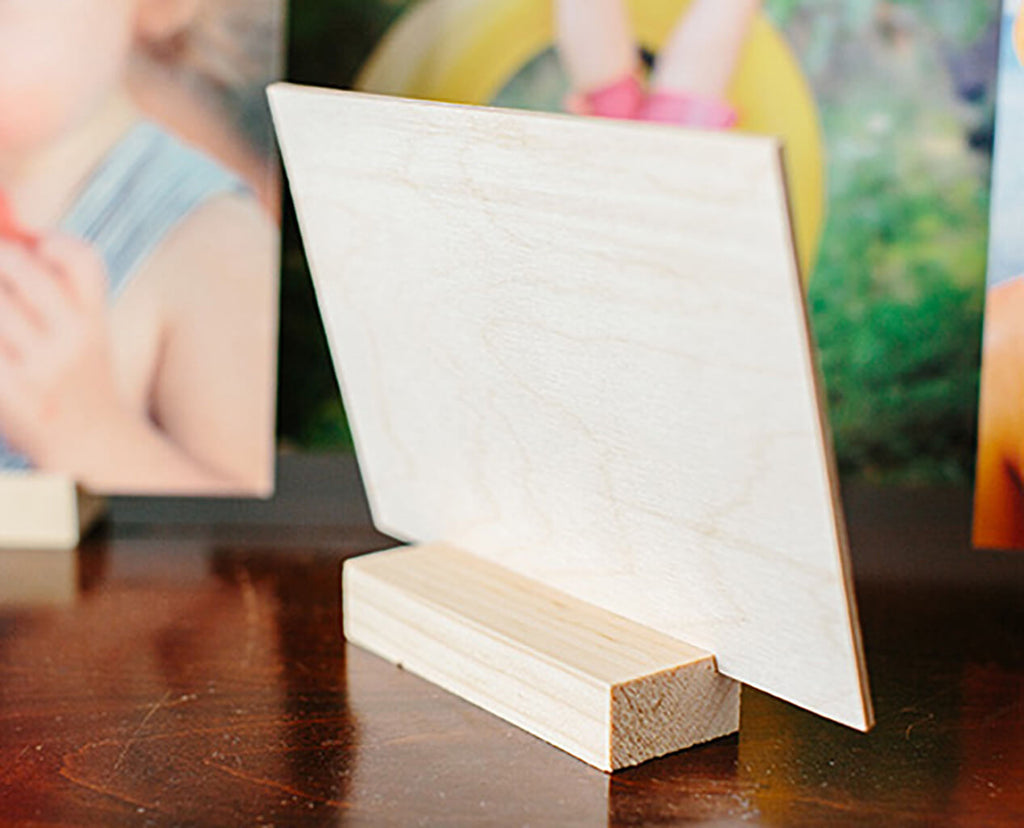 A rear view of a wood print showing the thickness of the wood and desk stand