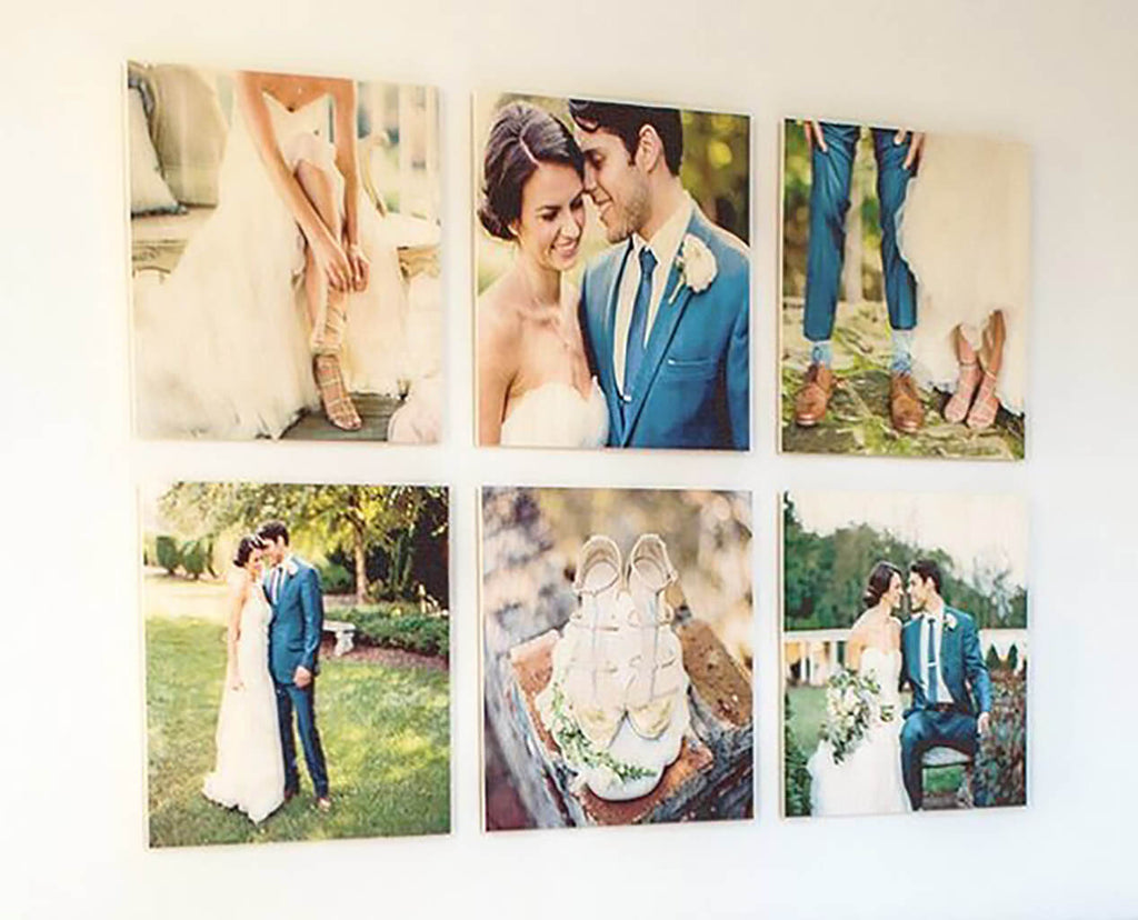 A set of 6 photoboard wood photo prints hanging in a grid pattern on a white wall