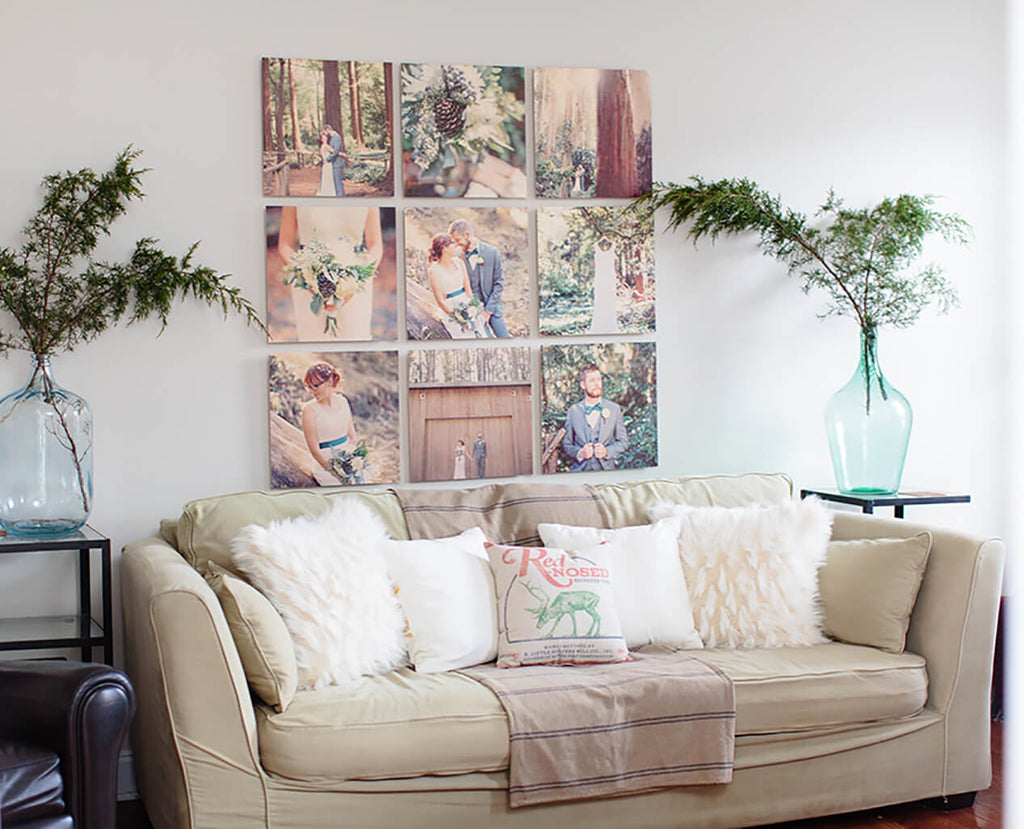 A set of 9 floatmount wood photo prints hanging in a grid pattern on a wall, above a couch.